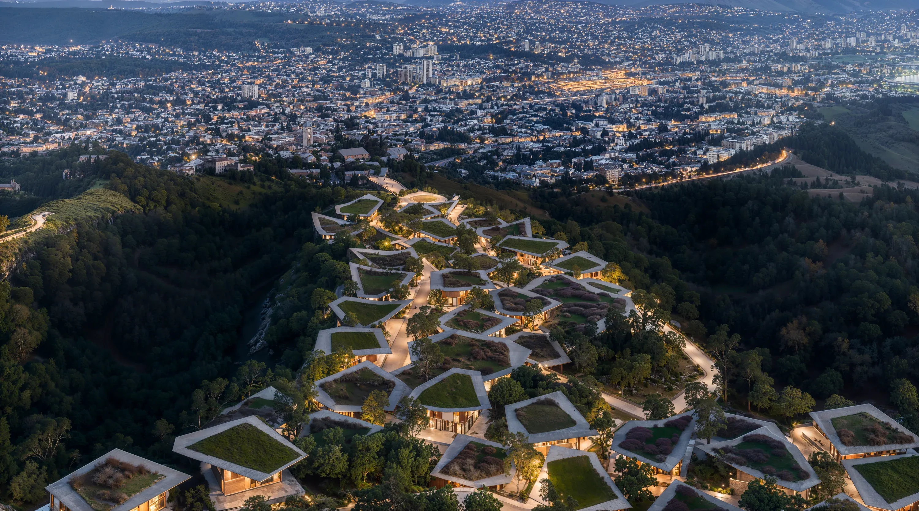 Mira Verde from the air at night, its green roofs above the lights of Tbilisi