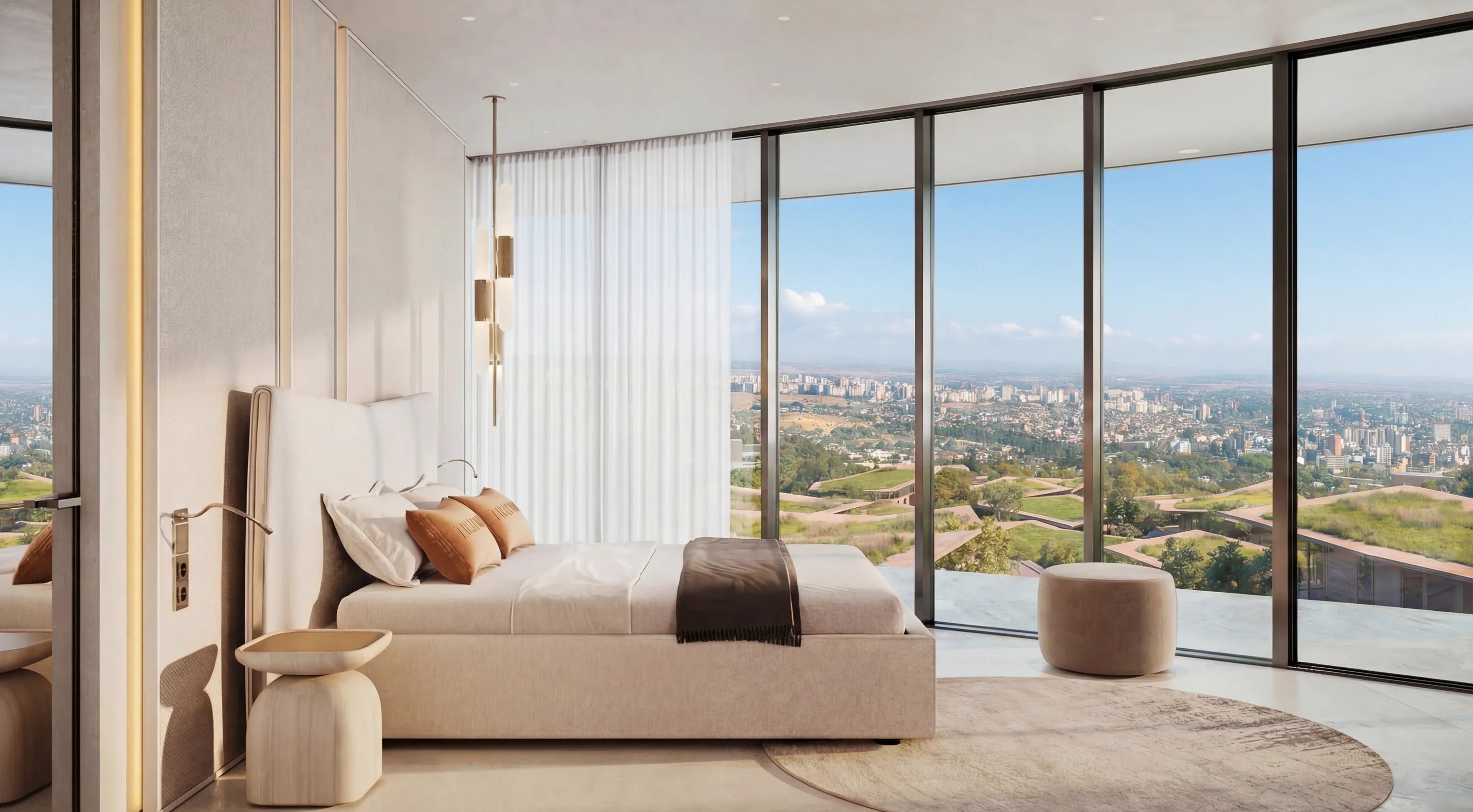 A Trussardi Casa bedroom in warm neutrals with branded cushions